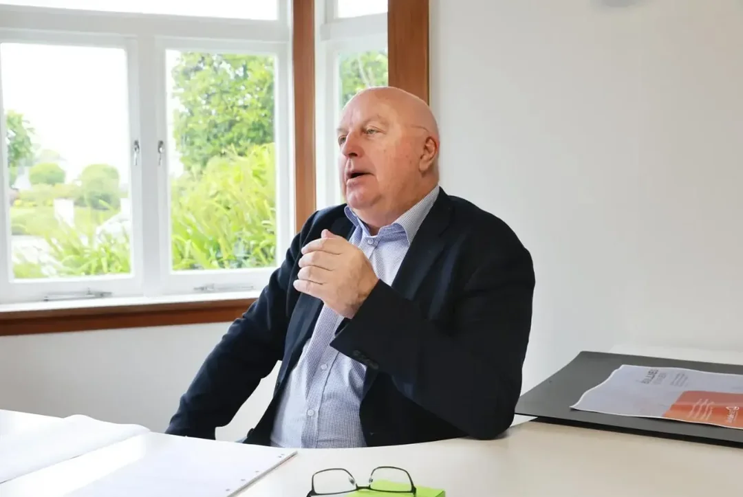 An employment advocate speaking during a meeting at an office table.
