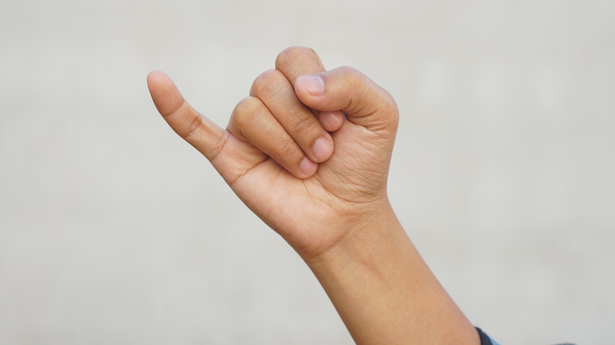 A close-up of a hand, illustrating claims about finger exercises and brain health.