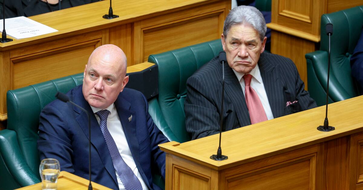 Prime Minister Christopher Luxon and New Zealand First leader Winston Peters seated in the debating chamber, illustrating the coalition agreement that produced the English Language Bill.